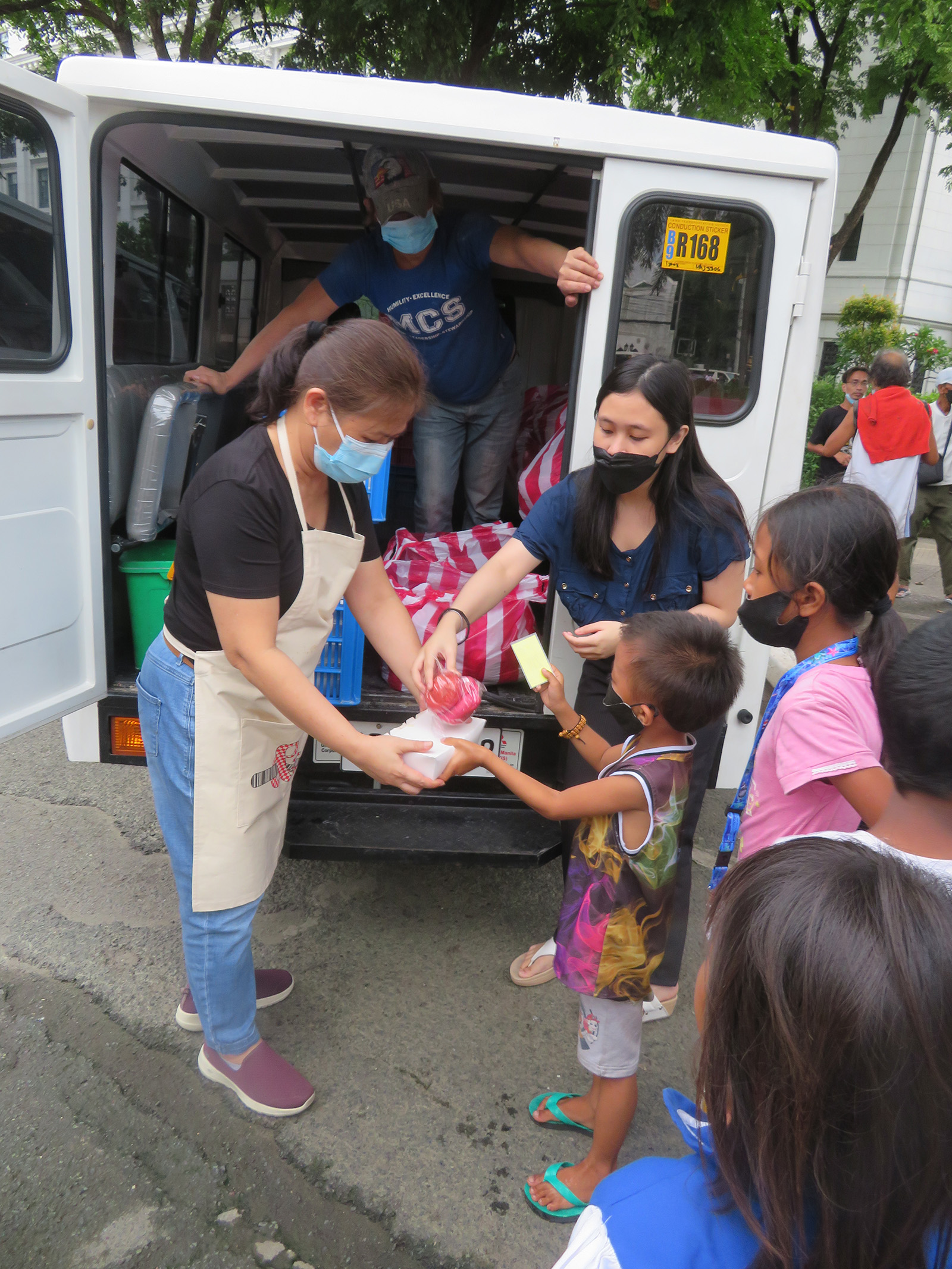 hands giving and receiving boxed food