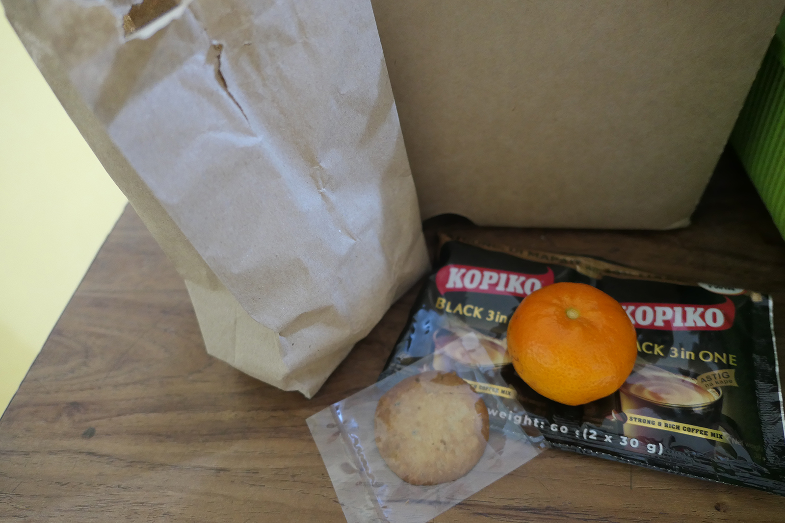 paper bag, orange, wrapped cookie, coffee packets
